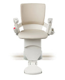 Otolift Modul-Air Smart stairlift chair in cream upholstery with the footrest folded, product view.