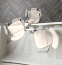 Top-down view of the Otolift Modul-Air Smart seat swivelled to three positions at the top landing of a staircase.