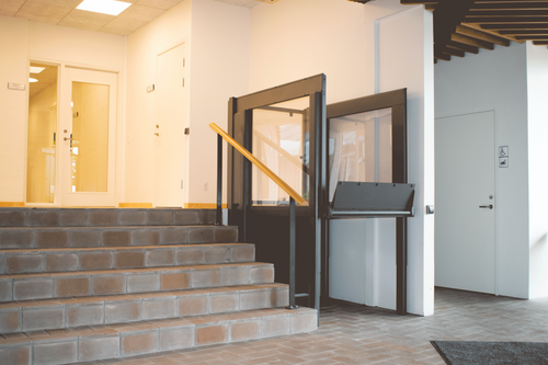 Liftup EasyLift low-rise platform lift installed beside brick steps at a building entrance