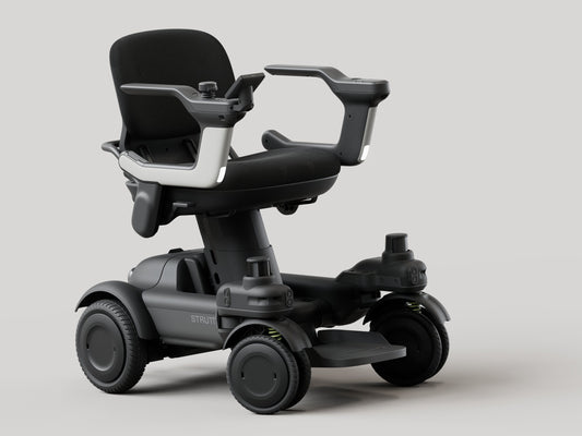 Strutt ev¹ smart power chair, front three-quarter studio view showing the seat, both armrests, footplate and four wheels