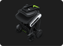 The WHILL Model C Lite folded, viewed from above: seat folded onto the frame, controller arm and wheels tucked in.